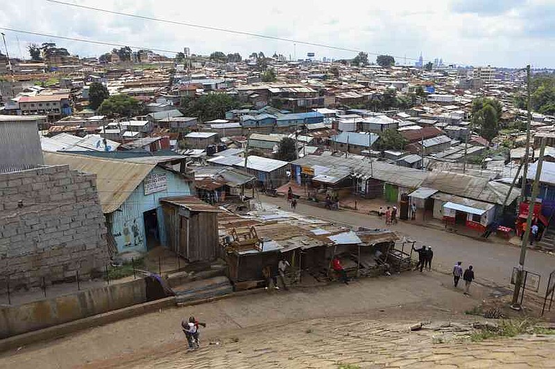 People walk in the streets of Kibera Slums in Nairobi, Kenya, Sunday, May 4, 2025. (AP Photo/Andrew Kasuku)