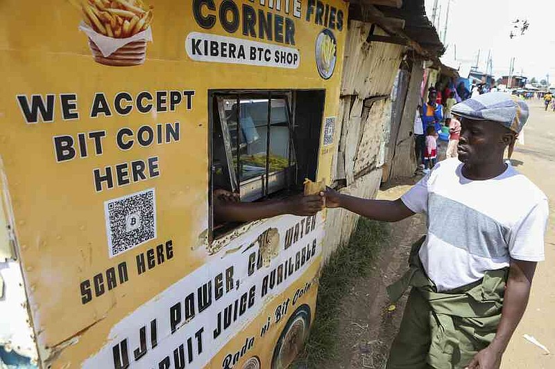 Kevin Gundo buys chips at a shop that accepts bitcoin payments at Kibera Slums in Nairobi, Kenya, Sunday, May 4, 2025.