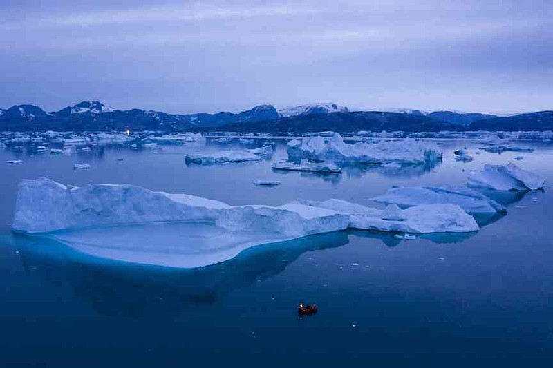 FILE - A boat navigates large icebergs near Kulusuk, in eastern Greenland, on Aug. 15, 2019. (AP Photo/Felipe Dana, File)