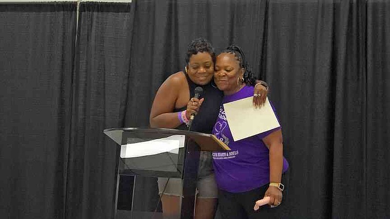 Beverly Blunt (right), founder and director of Delta Divine (3D), organized a Line Dance Fair on Saturday. Pine Bluff Ward 1 Councilor Latisha Brunson hugs Blunt during the welcome. (Pine Bluff Commercial/Eplunus Colvin)