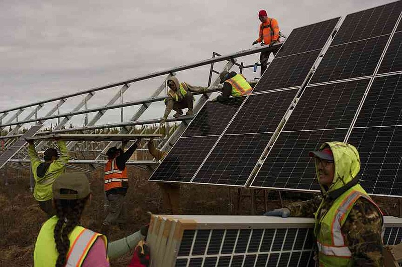 Workers install panels at a solar project Wednesday, May 21, 2025, in Galena, Alaska.