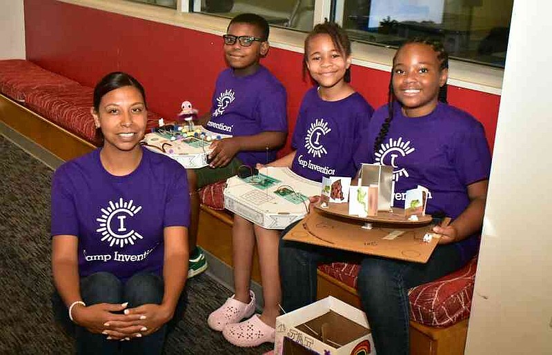 From left, Camp Invention teacher Claudia Lozano checks out inventions by Kaison Thorn, 9; Avery Martin, 11; and Jai'Yonni McDonald, 10. (Pine Bluff Commercial/I.C. Murrell)