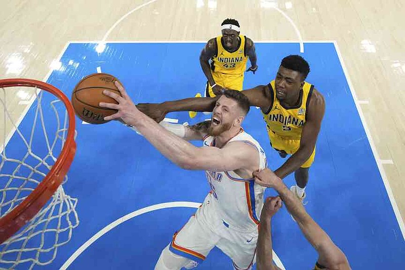 Oklahoma City Thunder center Isaiah Hartenstein, center, drives to the basket against Indiana Pacers center Thomas Bryant (3) during the first half in Game 1 of the NBA Finals basketball series Thursday, June 5, 2025, in Oklahoma City. (Kyle Terada/Pool Photo via AP)