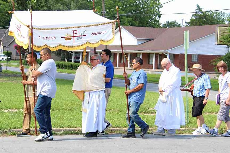 Participants in the Corpus Christi Procession 2025 travel from St. Peter's Catholic Church to St. Joseph Catholic Church on June 22. The main celebrants were the Rev. Andreas Kedati of St. Peter's and the Rev. Joseph Marconi of St. Joseph's. (Special to The Commercial/Brenda Baker)