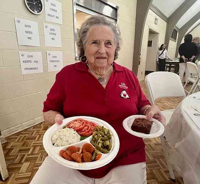 Judy Simmons, chair of the All-Tomato Luncheon, holds a plate of food at the event on June 14 at First United Methodist Church in Warren. Simmons has been a member of Bradley County Extension Homemakers Club for more than 25 years. (Special to The Commercial/University of Arkansas System Division of Agriculture)