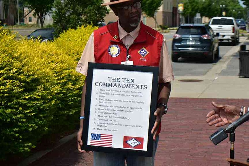 The Rev. Alexander Watkins of Pastors on Patrol displays a poster of the Ten Commandments at a news conference. (Pine Bluff Commercial/I.C. Murrell)