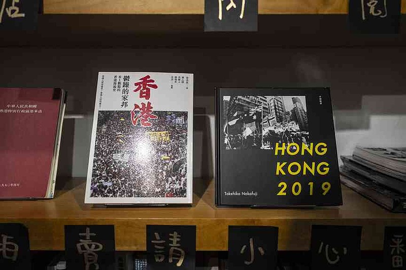 Books about Hong Kong politics are displayed on bookshelf at Leticia Wong's bookstore in Hong Kong, Friday, June 20, 2025. (AP Photo/Chan Long Hei)