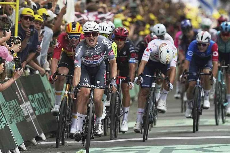 Belgium's Jasper Philipsen celebrates as he crosses the finish line to win the first stage of the Tour de France cycling race over 184.9 kilometers (114.9 miles) with start and finish in Lille, France, Saturday, July 5, 2025. (AP Photo/Thibault Camus)