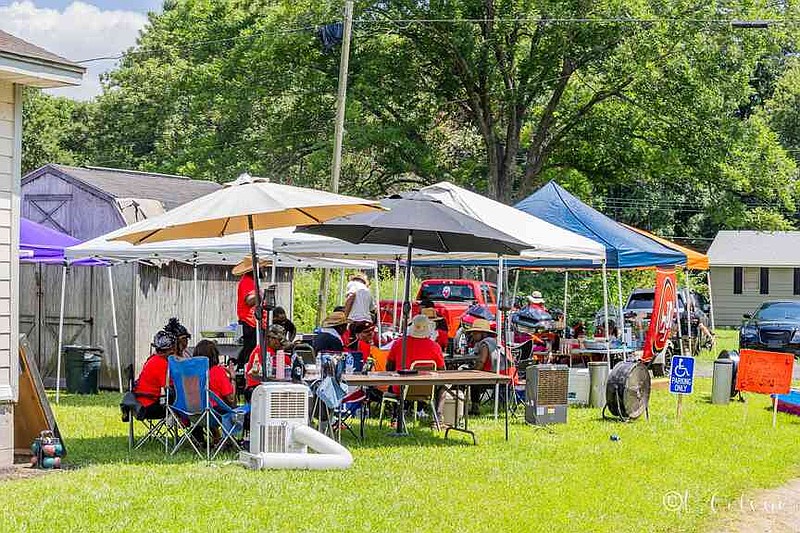 Families enjoy food, fun, and fellowship, gathering from Cherry Street to Second Street to celebrate Rock Island Day. (Pine Bluff Commercial/Eplunus Colvin)