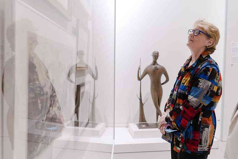Rep. Denise Garner looks at art Thursday during a ribbon cutting ceremony for a new Crystal Bridges satellite gallery at the Northwest Arkansas National Airport. Northwest Arkansas National Airport (XNA) and Crystal Bridges Museum of American Art invited press to attend a ribbon cutting ceremony celebrating the opening of the museum's new satellite gallery in the airport terminal. Visit nwaonline.com/photo for today's photo gallery. (NWA Democrat-Gazette/Charlie Kaijo)