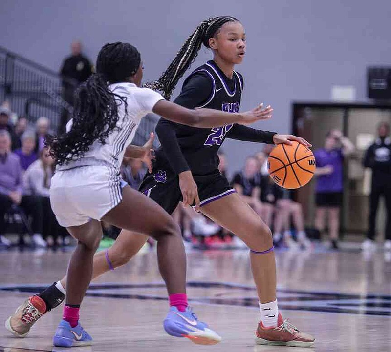 Fayetteville guard Syniah Coachman (23) runs the perimeter Friday, Feb. 7, 2025, as Springdale Har-Ber guard Brooklyn Owens (2) defends during the first half of play at Wildcat Arena in Springdale. Coachman left Fayetteville for Har-Ber during the offseason. (Special to the NWA Democrat-Gazette/Brent Soule)