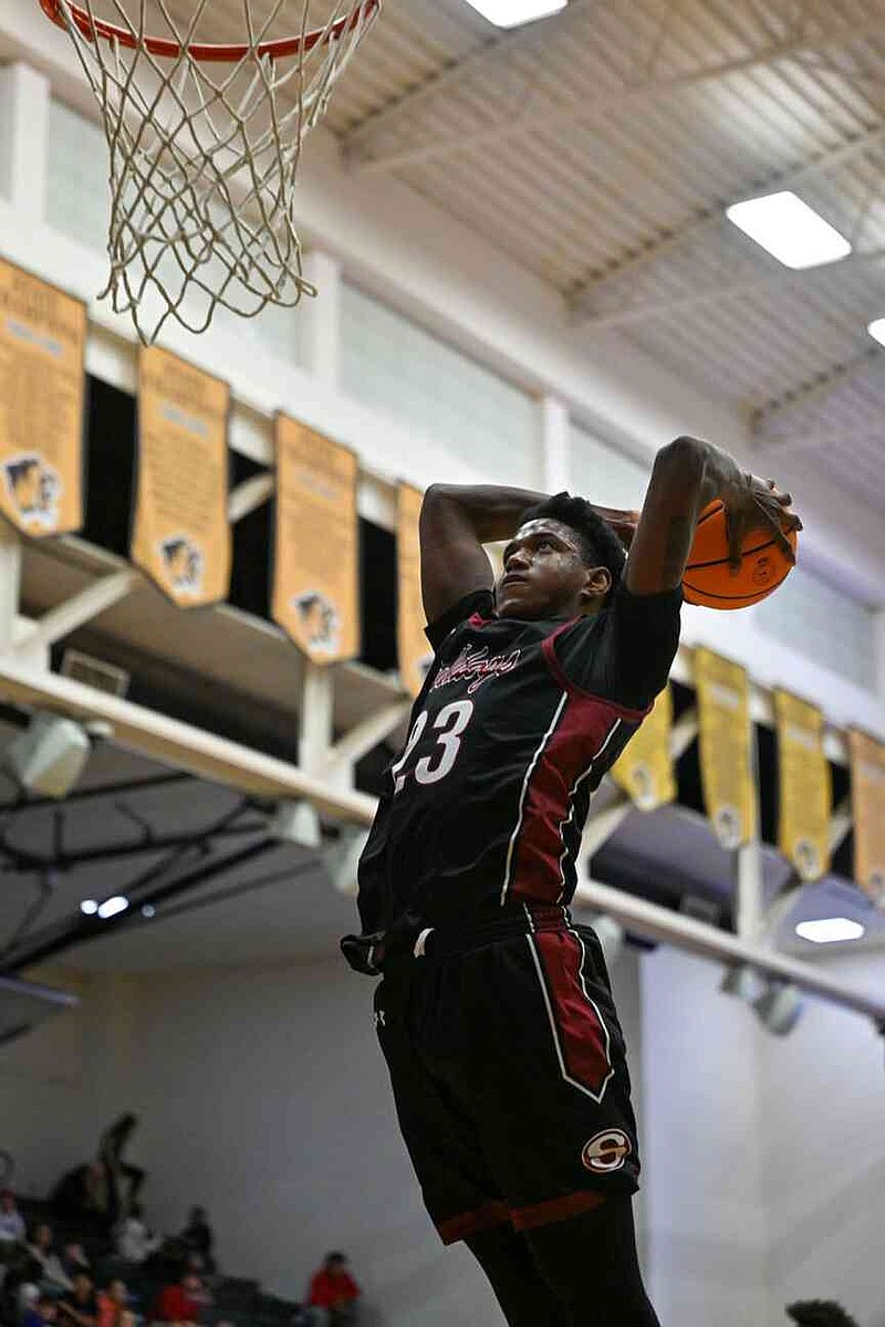 Springdale's DJ Hudson (23) dunks the ball during the first quarter of a basketball game Tuesday, Feb. 25, 2025, at Tiger Arena in Bentonville. Hudson will play his senior season at Fayetteville, where he played as a sophomore before he transfered to Springdale last season. (NWA Democrat-Gazette/Caleb Grieger)