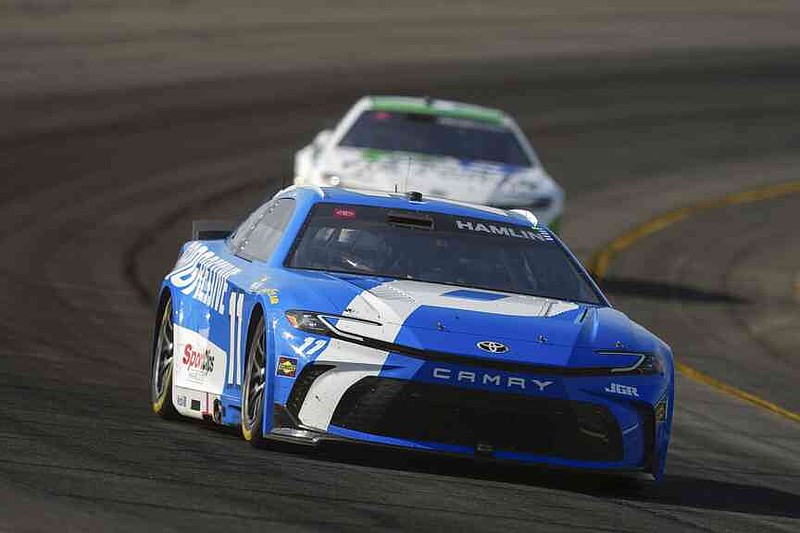 Denny Hamlin drives through Turn 3 during a NASCAR Cup Series auto race at Pocono Raceway, Sunday, June 22, 2025, in Long Pond, Pa. (AP Photo/Derik Hamilton)