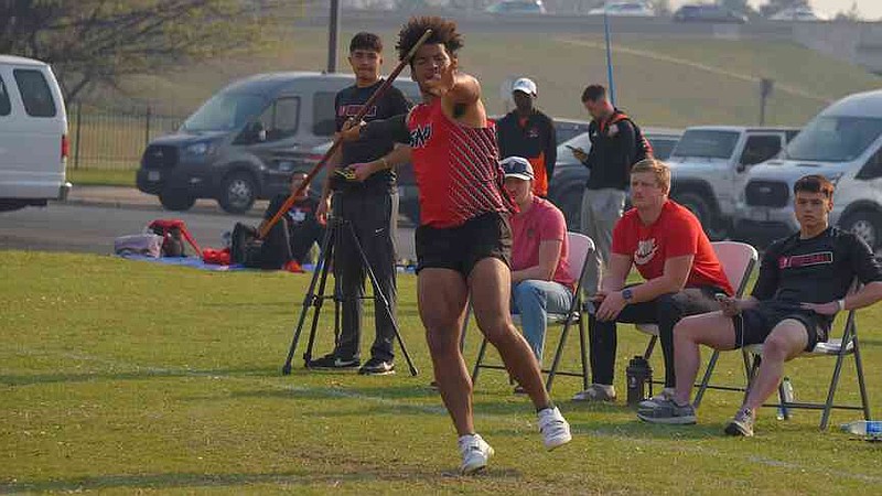Southern Nazarene track and field athlete Colter Bufford, center, throws a javelin. (Submitted photo)