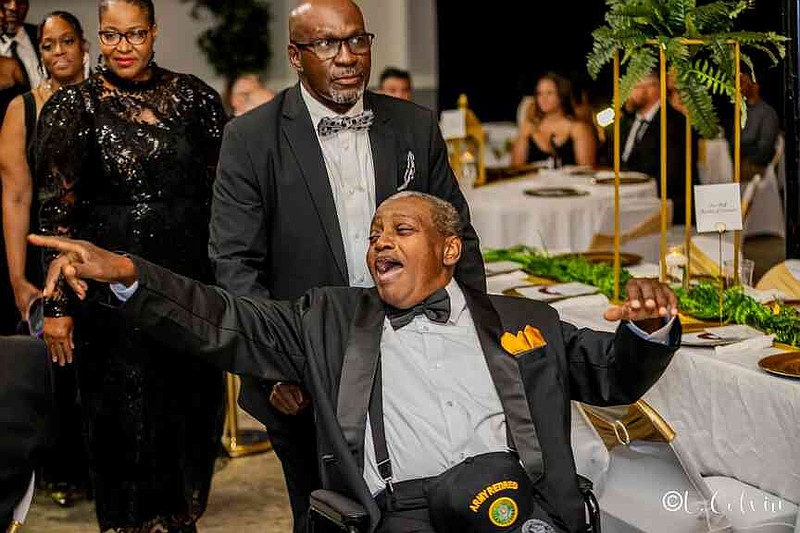 Former Circuit Court Clerk Lafayette Woods Sr., the sheriff's father, greets the crowd during the family processional. (Pine Bluff Commercial/Eplunus Colvin)