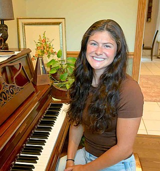 Kayla Rupp/Westside Eagle-Observer
Maci Layne Hubbard sits at her piano at her family's home in Decatur on July 31.