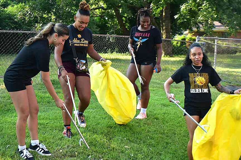 From left: Brooke Gonzalez, Ashlynn Tipler, Zakhoriah Jones and Keissy Hopes of the UAPB women's soccer team pick up trash down Elm Street. (Pine Bluff Commercial/I.C. Murrell)