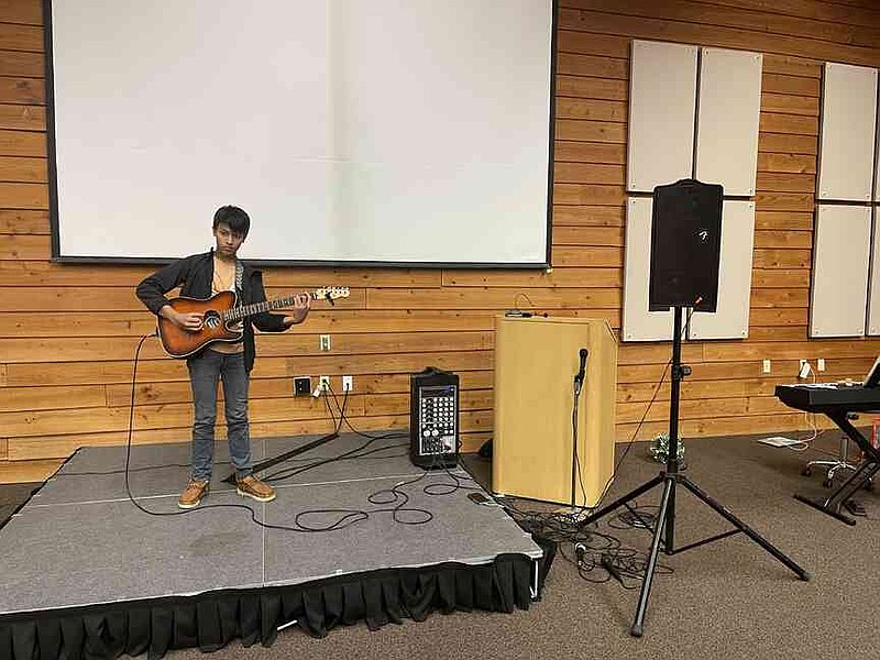 Kruz Ho, a member of Garland County 4-H, plays a guitar rendition of 'Piano Man' by Billy Joel. (Special to The Commercial/University of Arkansas System Division of Agriculture)