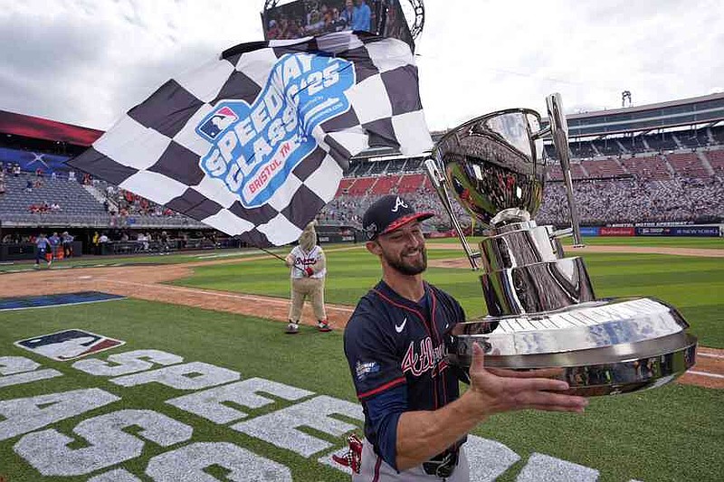 Atlanta Braves outfielder Eli White holds the trophy after their win against the Cincinnati Reds I the MLB Speedway Classic baseball game at Bristol Motor Speedway in Bristol, Tenn., Sunday, Aug. 3, 2025. Play was resumed today after yesterday's weather delay. (AP Photo/George Walker IV)