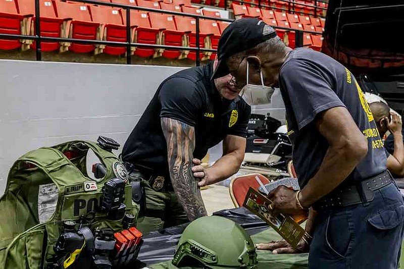 Pine Bluff Police Lt. Brett Talley talks with a Pine Bluff resident. (Pine Bluff Commercial/Eplunus Colvin)