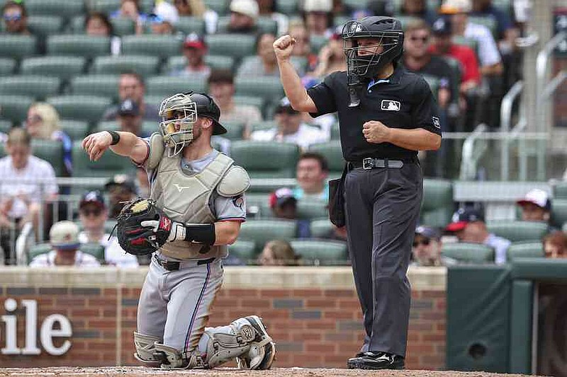 Home plate umpire Jen Pawol signals a strikeout in the third inning of a baseball game between the Miami Marlins and Atlanta Braves, Sunday, Aug. 10, 2025, in Atlanta. (AP Photo/Colin Hubbard)