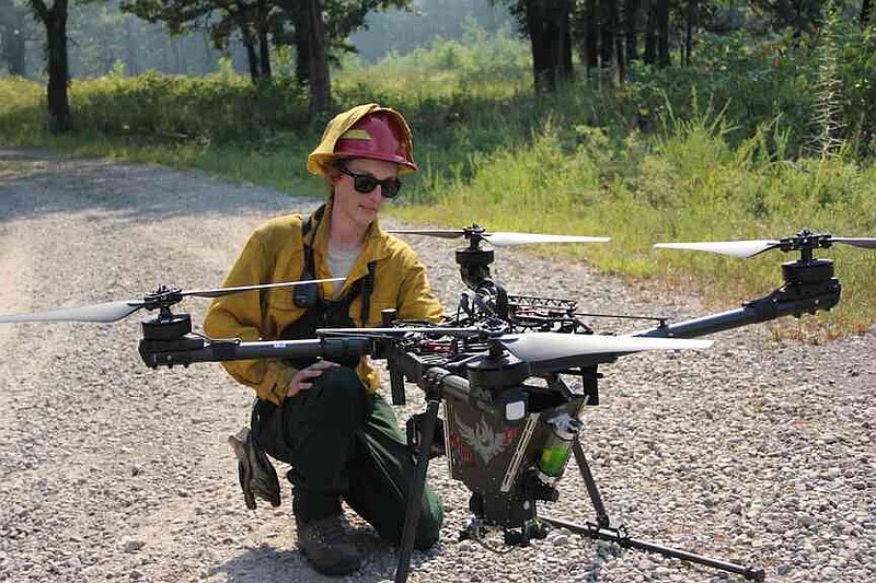 Emily Roberts worked with an aerial drone to keep tabs on the burn and ensure good coverage. (Special to The Commercial/Keith Stephens/Arkansas Game and Fish Commission)