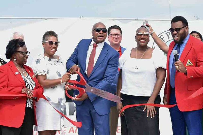 From left: Robbie Williams of the Pine Bluff Regional Chamber of Commerce Redcoats, Chandra Griffin of Pine Bluff Urban Renewal Agency, Ryan Watley of Go Forward Pine Bluff, Chad Pittillo of Simmons Bank, Mayor Vivian Flowers and Jamal Gordon of the Redcoats ceremonially open Simmons Bank Park. (Pine Bluff Commercial/I.C. Murrell)
