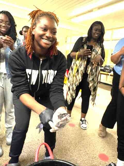 A student catches a catfish in the aquaponics system at Watson Chapel Junior High School. (Special to The Commercial/University of Arkansas at Pine Bluff)