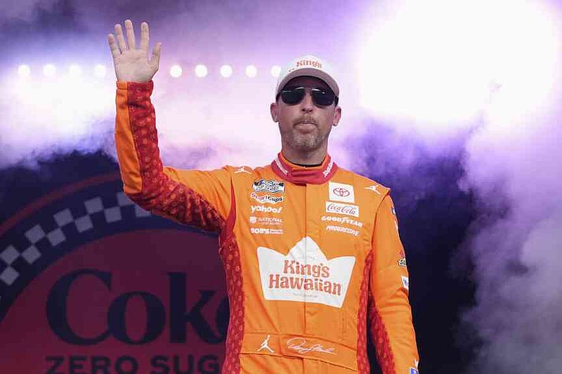 Denny Hamlin waves to fans during driver introductions before the NASCAR Cup Series auto race at Daytona International Speedway, Aug. 23, 2025, in Daytona Beach, Fla. (AP Photo/John Raoux)