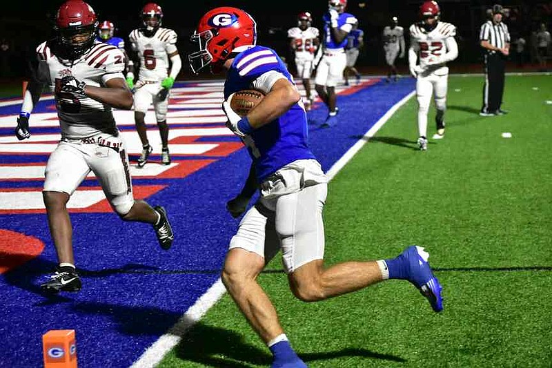 Grenada tight end Andrew Fair runs into the end zone on a touchdown reception against Pine Bluff High School linebacker Kaden Poole in the third quarter Friday night, Aug. 29, 2025, in Grenada, Miss. (Pine Bluff Commercial/I.C. Murrell)