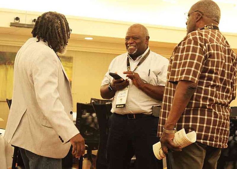 Keeping it in the Family program team members include Charley Williams, left, and Levell Foote, speaking with Woodson Walker, a Conway County landowner. (Special to The Commercial/University of Arkansas at Pine Bluff)