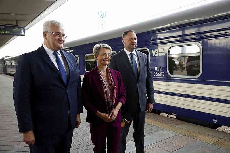 Ukrainian Foreign Minister Andrii Sybiha, left, and Head of the Office of the President of Ukraine Andriy Yermak, right, welcome British Foreign Secretary Yvette Cooper upon her arrival at a railway station, amid Russia's attack on Ukraine, in Kyiv, Ukraine, Friday Sept. 12, 2025. (Valentyn Ogirenko/Pool Photo via AP)