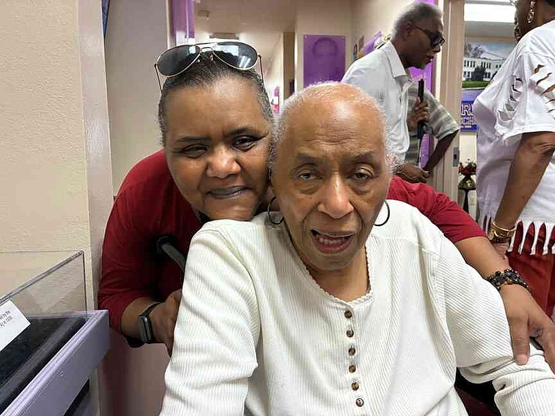 Mary Banks Lee, Class of 1945, who will be 99 in a few days, poses with her daughter, Gayle Morris, during the opening of the Merrill Historical Museum. (Pine Bluff Commercial/Byron Tate)