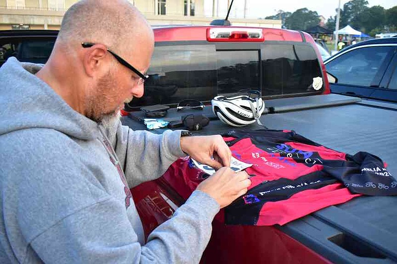 Mark Pharr of Maumelle pins a number on his jersey before the start. (Pine Bluff Commercial/I.C. Murrell)
