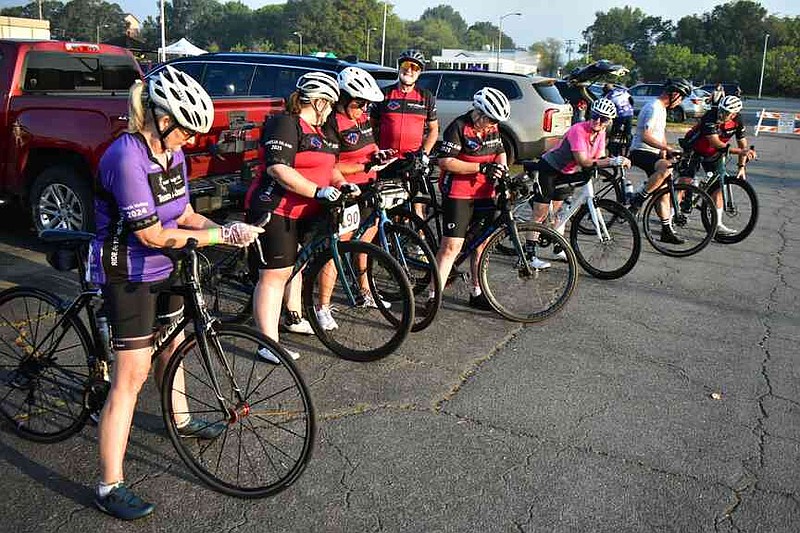 Members of Team Arkansas pull their bikes out front before the start of Tour de Bluff. (Pine Bluff Commercial/I.C. Murrell)