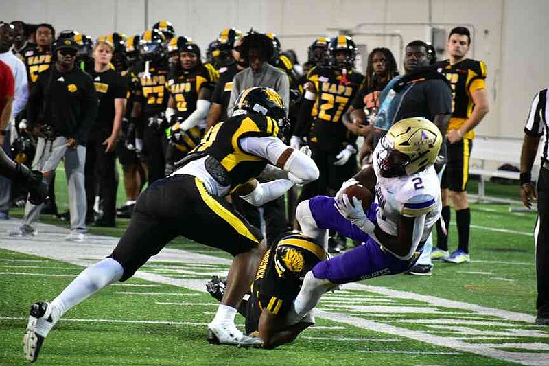Alcorn State running back Reggie Davis (2) is tackled after a big carry by UAPB defensive back Tavon Hardwick as Ja'Marlin Green closes in. (Pine Bluff Commercial/I.C. Murrell)