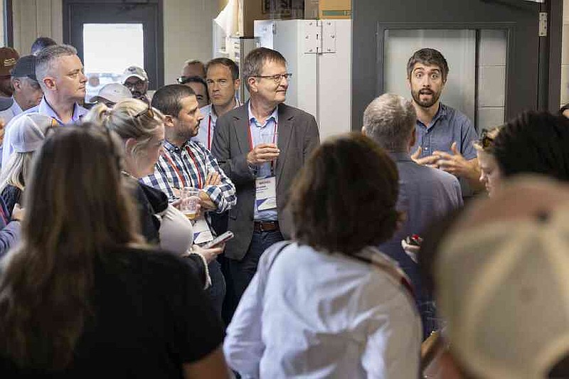 During a tour of the Center for Beverage Innovation, attendees heard from Scott Lafontaine, right, assistant professor of food science with Bumpers College and the University of Arkansas System Division of Agriculture. The division hosted representatives from approximately 25 countries Sept. 18 as part of a tour organized by the National Association of State Departments of Agriculture. (Special to The Commercial/Paden Johnson/University of Arkansas System Division of Agriculture)