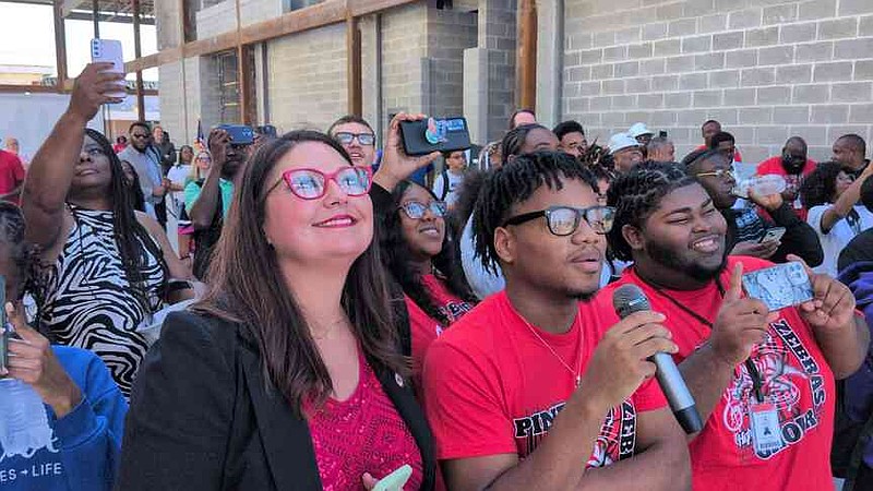 Pine Bluff School District Superintendent Jennifer Barbaree watches the placement of the final beam along with student council executive cabinet President Adam Price and student Malakhi Haymer. (Pine Bluff Commercial/I.C. Murrell)
