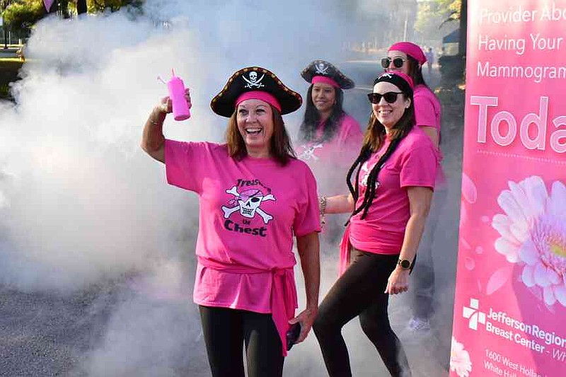 From left: Mammographers Kathryn Watson, Cristina Heredia, Felicia Dutton and Kayley Spivey cheer on runners as they run down a backstretch of the 5K course. (Pine Bluff Commercial/I.C. Murrell)