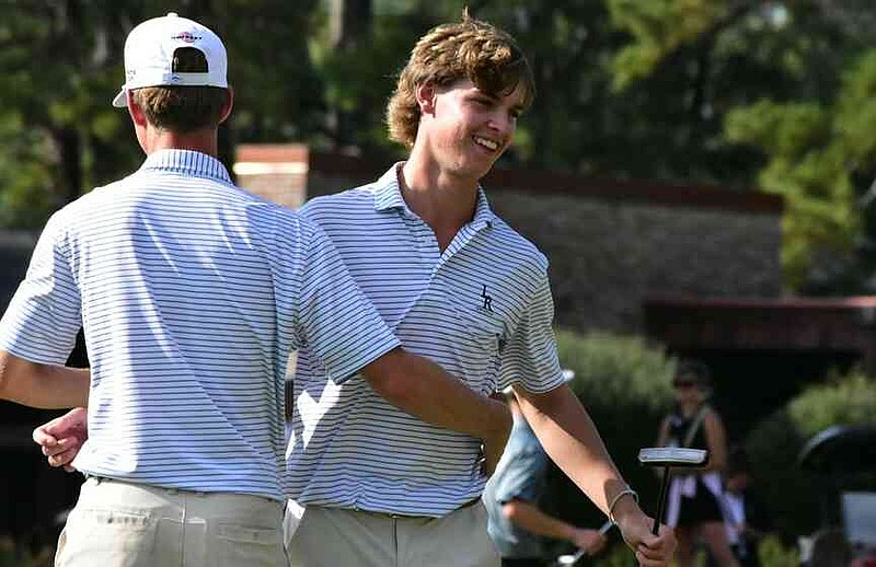 Hogan O'Keefe of Little Rock Christian Academy hugs a teammate after his successful putt on the 18th hole at the 5A state championship tournament Wednesday, Oct. 8, 2025, at the Pine Bluff Country Club. (Pine Bluff Commercial/I.C. Murrell)