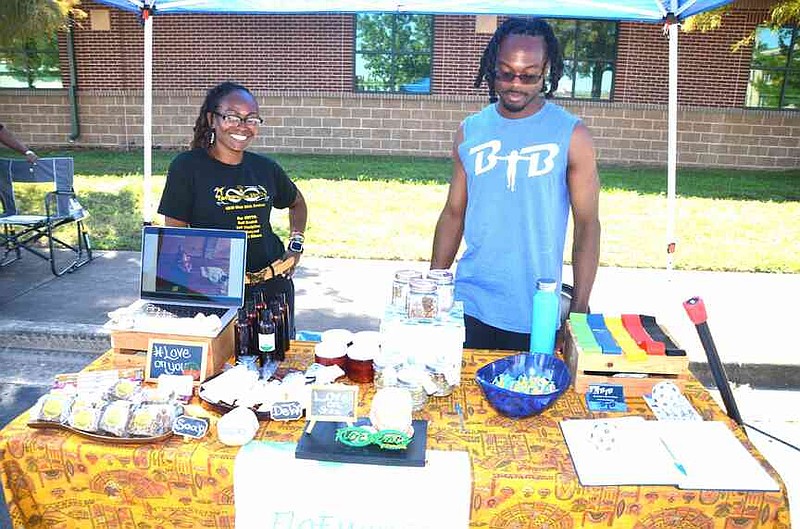 Flo Love, left, and Blair Hudson offered their yoga, Taekwondo and physical fitness services to expo attendees. (Special to The Commercial/Richard Ledbetter)
