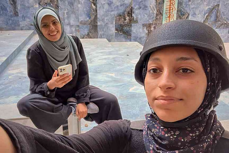 Fatima Shbair, right, takes a selfie next to colleague and friend Mariam Dagga, in Gaza City, Thursday, Oct. 12, 2023.(Ap Photo/Fatima Shbair)