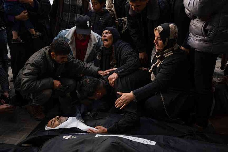 FILE.- Palestinians mourn relatives killed in a Israel strike at a hospital morgue in Rafah, southern Gaza Strip, on March 4, 2024. (AP Photo/Fatima Shbair,File)