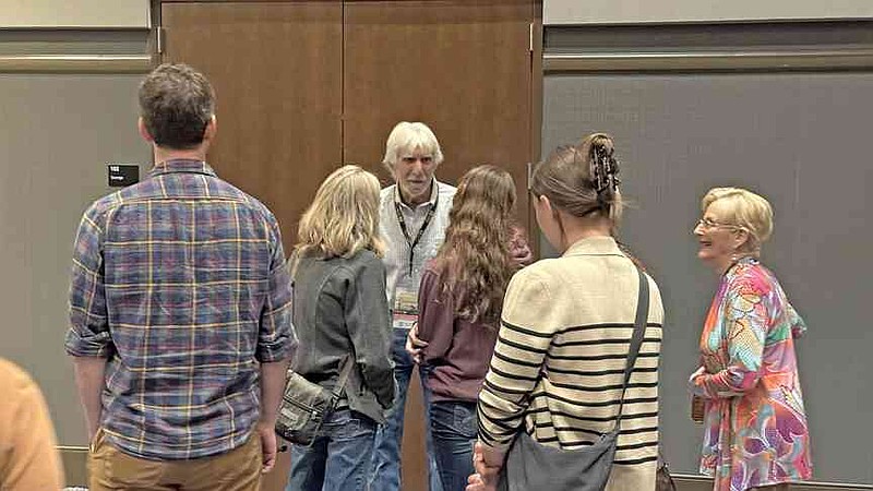 Rick Beattie, center, one of the subjects of the film Lost Wolves of Yellowstone, speaks to attendees following the screening of the film at Oaklan Event Center. The film was the opening night gala film. (The Sentinel-Record/James Leigh)