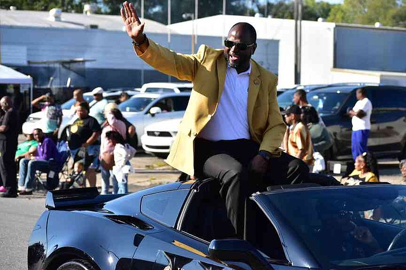 Anthony Graham waves to the crowd during his first homecoming parade as UAPB chancellor. (Pine Bluff Commercial/I.C. Murrell)