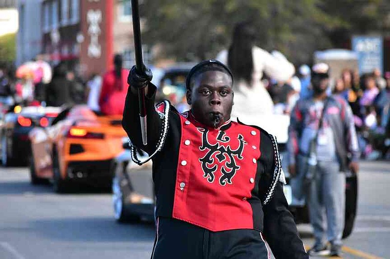 A Pine Bluff High School drum major leads the band up Main Street. (Pine Bluff Commercial/I.C. Murrell)