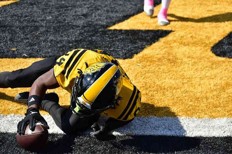 UAPB wide receiver D'Avery Robinson slides at the end of his over-the-shoulder touchdown catch in the first quarter. (Pine Bluff Commercial/I.C. Murrell)