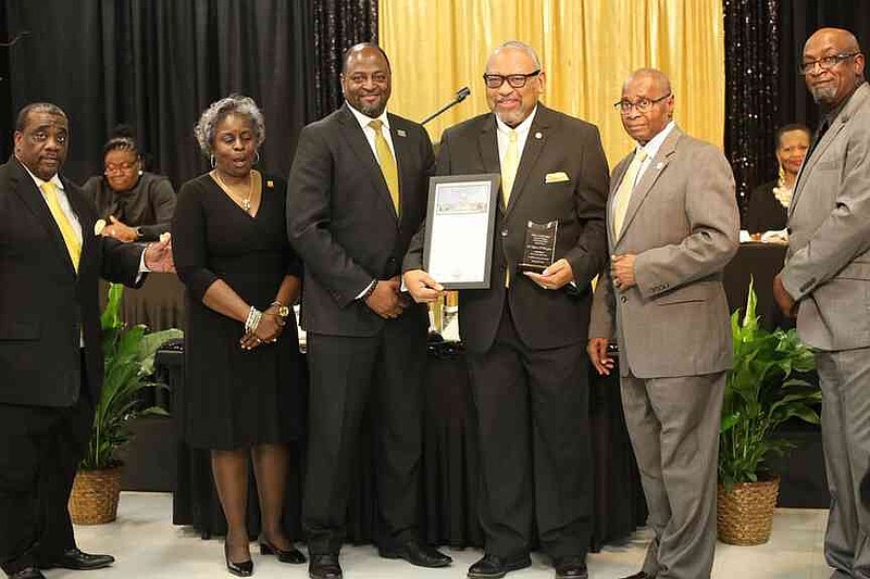 Dr. Stephen A. Broughton, center, was recognized for medicine. He was among the award recipients for outstanding service. (Special to The Commercial/The Heat Magazine)