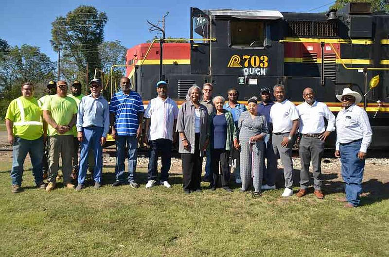 A large group representing North Louisiana & Arkansas Railroad, Southeast Arkansas Economic Development District, and Ida Newbill's family stood in front of the vintage NLA engine #703. (Special to The Commercial/Richard Ledbetter)