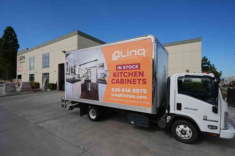 A truck stands outside a show room and warehouse belonging to Linq Kitchen, a designer and maker of kitchen cabinets in City of Industry, Calif., Friday, Oct. 10, 2025. (AP Photo/Damian Dovarganes)